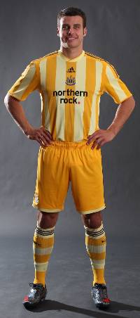 Steven Taylor models Newcastle United's new change strip which has been dubbed 'Toongerine orange'